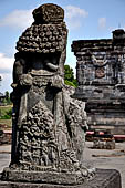 Candi Panataran - Main Temple. Back side of one of the giant guardian to left of the staircase of the temple with relief of tantri tale depicting small animals setting each other free.  